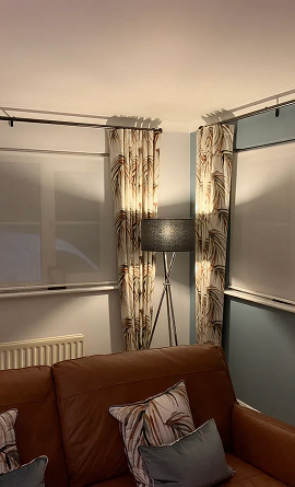 Wave headed curtains handing from silent gliss metropoles img